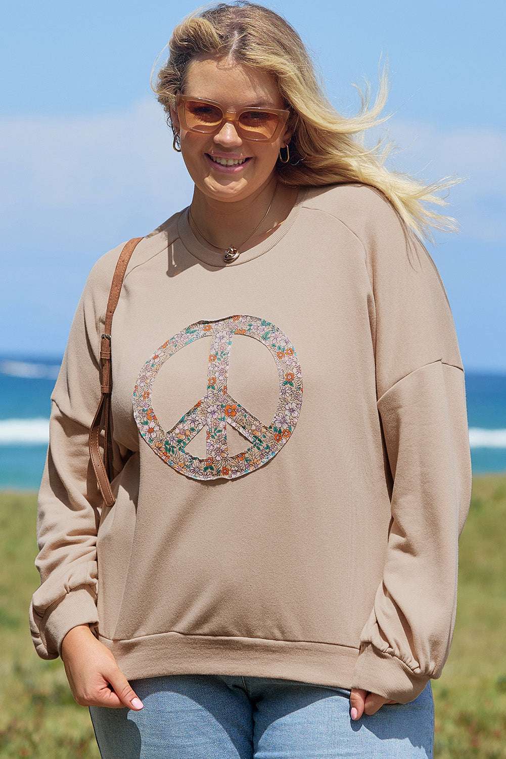 A pale khaki plus-size sweatshirt featuring a floral peace sign graphic and a Washed Terry Finish