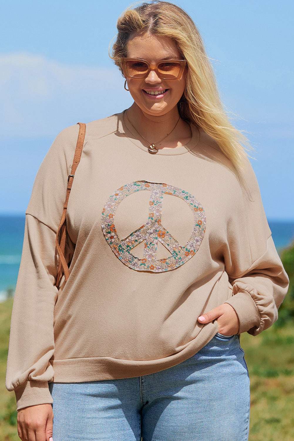 A pale khaki plus-size sweatshirt featuring a floral peace sign graphic and a Washed Terry Finish