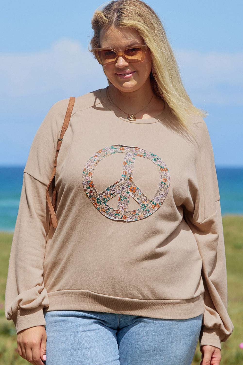 A pale khaki plus-size sweatshirt featuring a floral peace sign graphic and a Washed Terry Finish