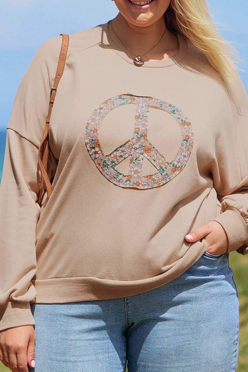 A pale khaki plus-size sweatshirt featuring a floral peace sign graphic and a Washed Terry Finish