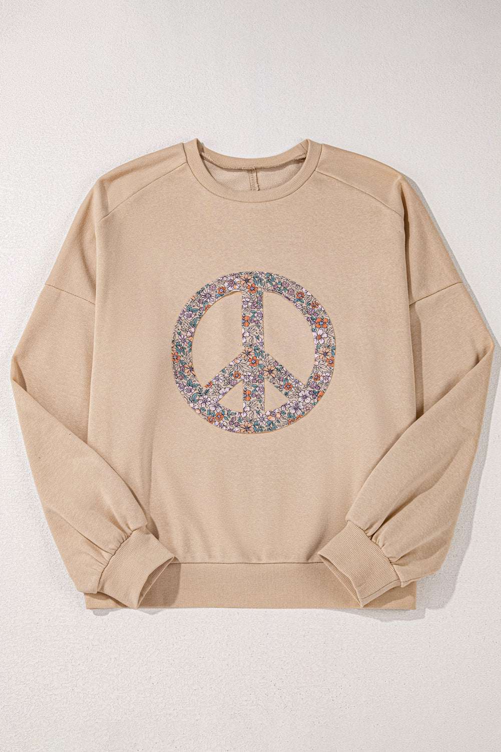 A pale khaki plus-size sweatshirt featuring a floral peace sign graphic and a Washed Terry Finish